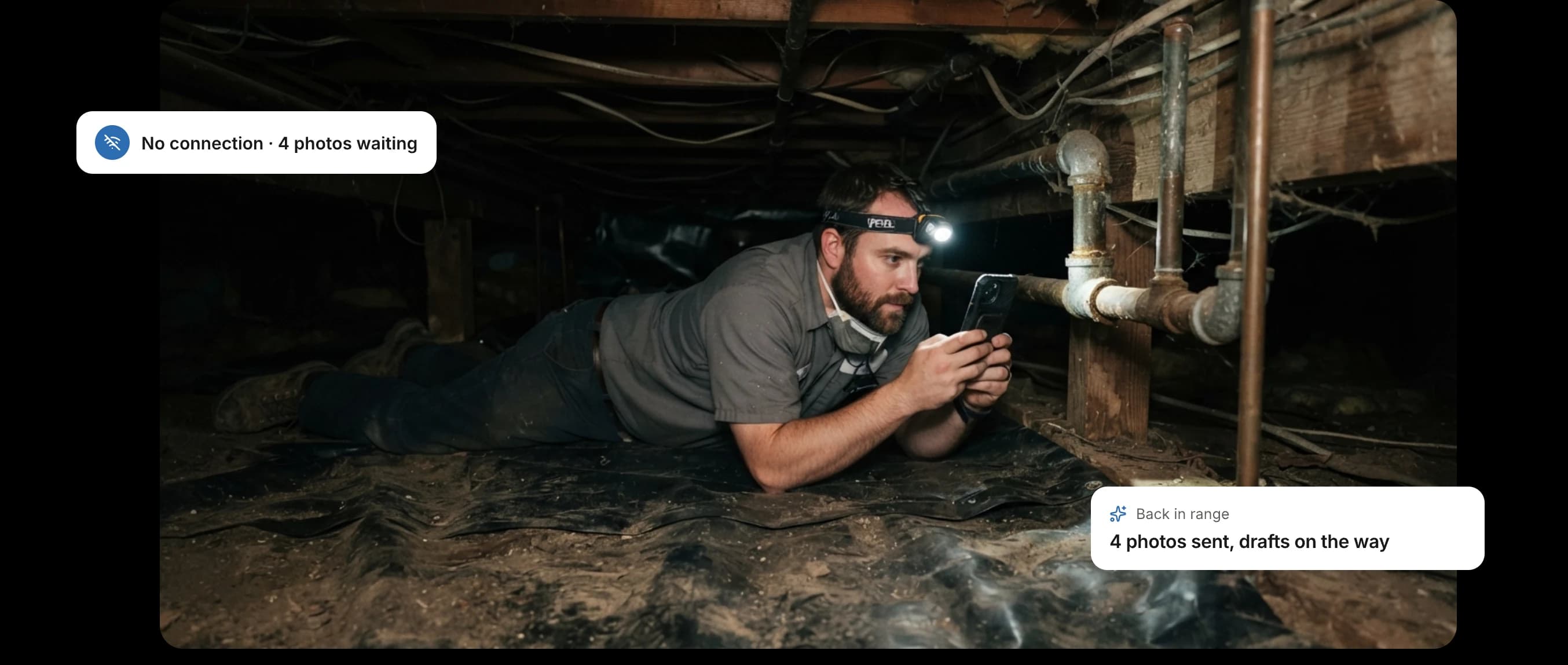An inspector in a crawlspace with photos waiting to send